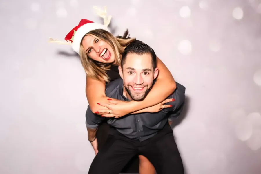 Couple at photo booth with reindeer prop